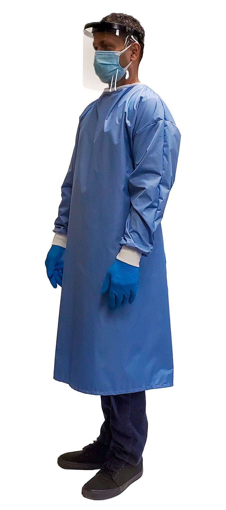 Man wearing a Fast Reusable Isolation Gown4000 Level 2 made with anti-static blue polyester material. Canadian Made. Profile view.
